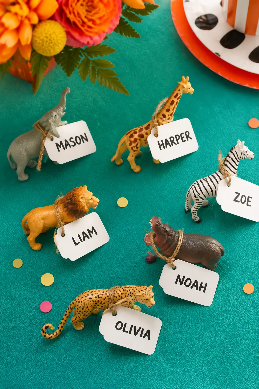 Mini Animal Figurine as Place-Card and Favour — A small plastic safari figurine with a card label tied around its neck by a short length of twine does two