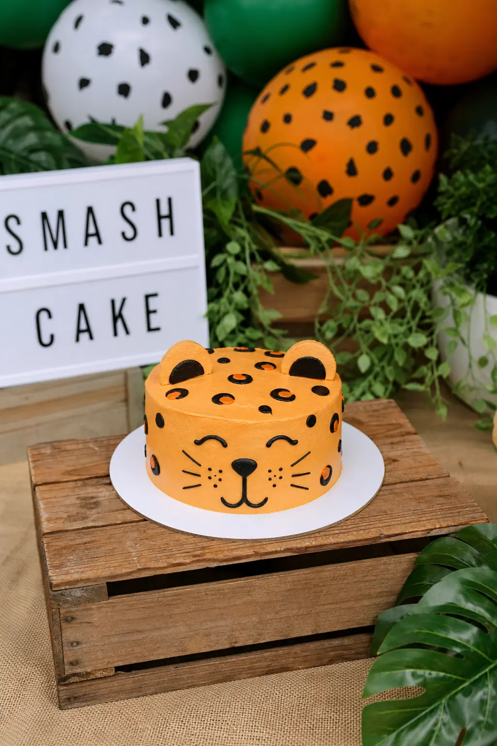 Smash Cake Station for the Birthday Child — A single small round cake on its own low table, sized for a toddler or a young child to reach without stretching