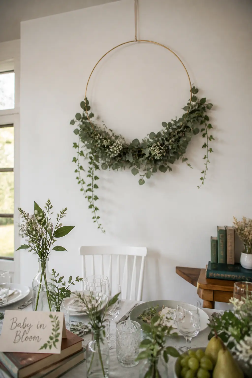 Single Foliage Hoop Backdrop — Hang a sixty-centimetre gold or brass hoop from a ceiling hook or a freestanding frame and weave fresh or dried eucalyptus