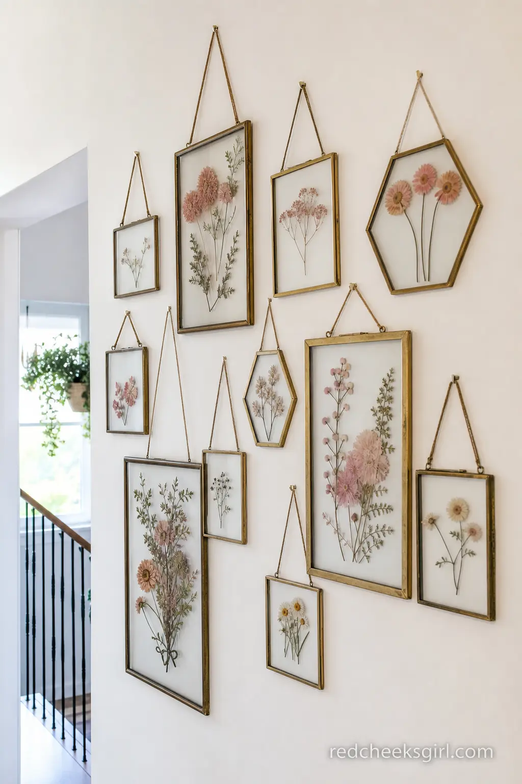 Dusty Rose Pressed Botanical Wall — A hallway or entry wall dressed with a cluster of simple frames holding pressed flowers in dusty rose and cream reads as