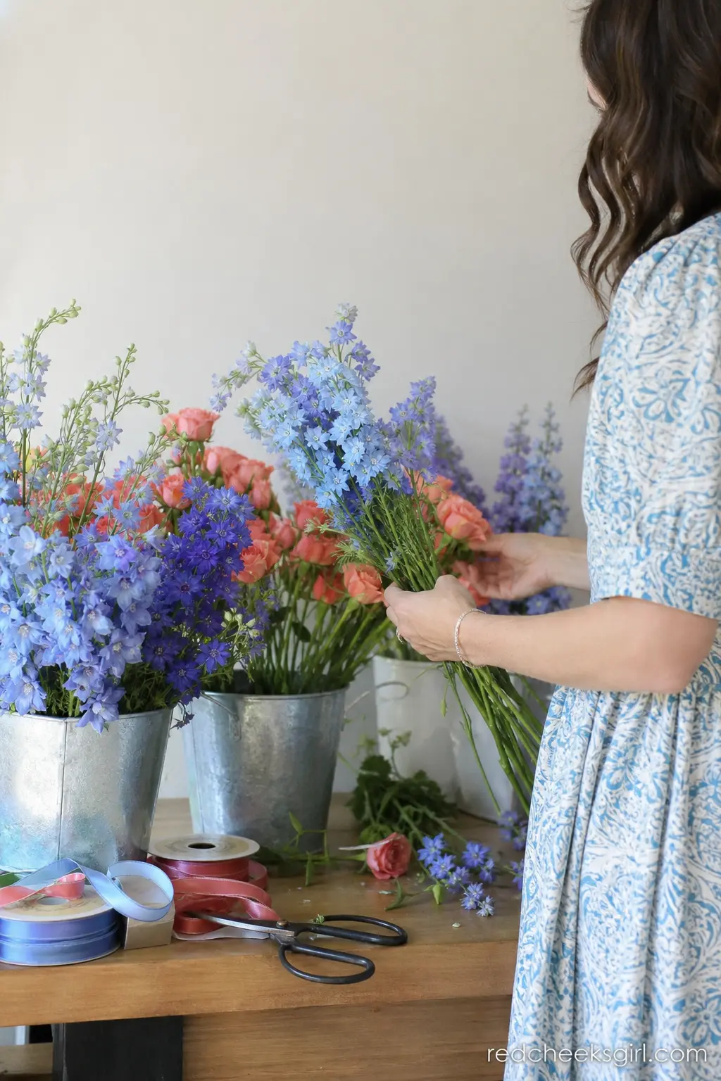 Periwinkle and Coral Flower Bar Station — A small station stocked with periwinkle and coral stems, ribbon and a few pairs of shears lets guests build a tiny