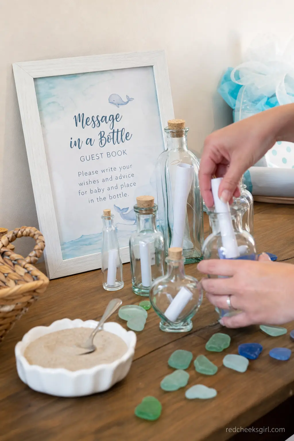 Message in a Bottle Guest Book Station — Instead of a book to sign, a cluster of small glass bottles filled with rolled paper wishes gives guests a tiny craft