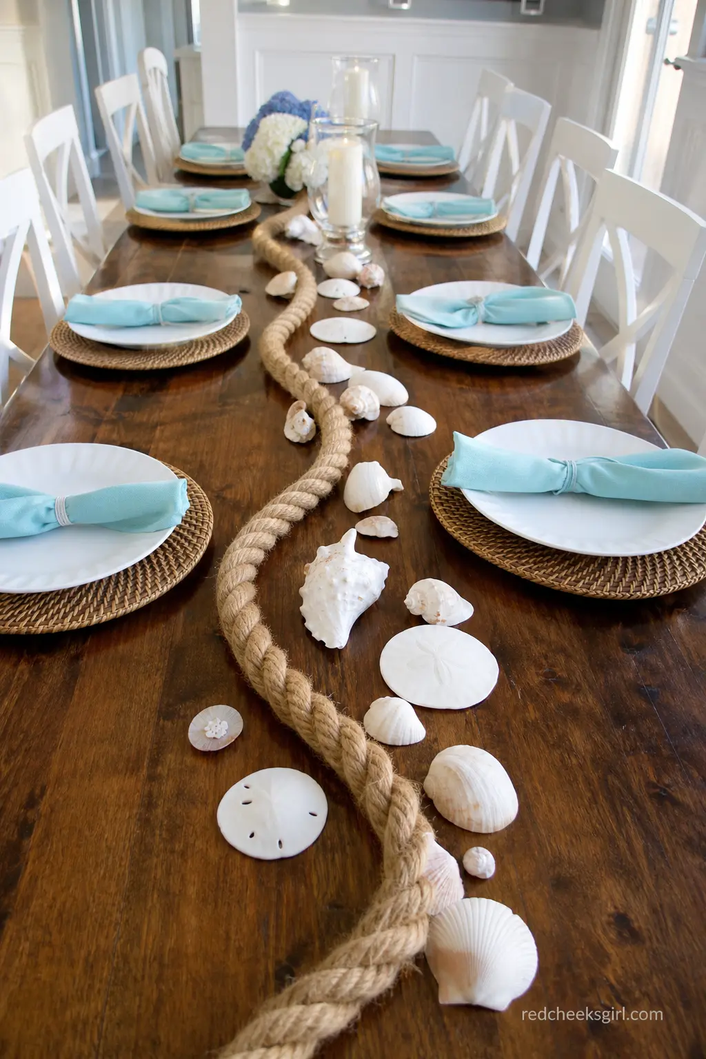 Rope and Shell Table Runner — A thick jute rope laid straight down the middle of a long table, scattered with a few real shells and sand dollars, gives a