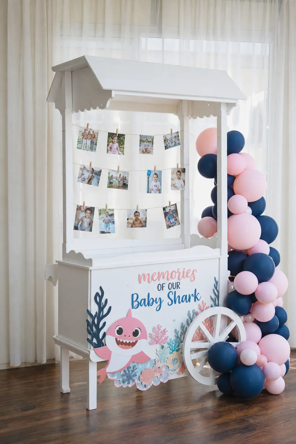 Vintage Cart Memory Display — A small white wooden cart, the kind usually used for dessert display, works just as well strung with clothespinned photos of the