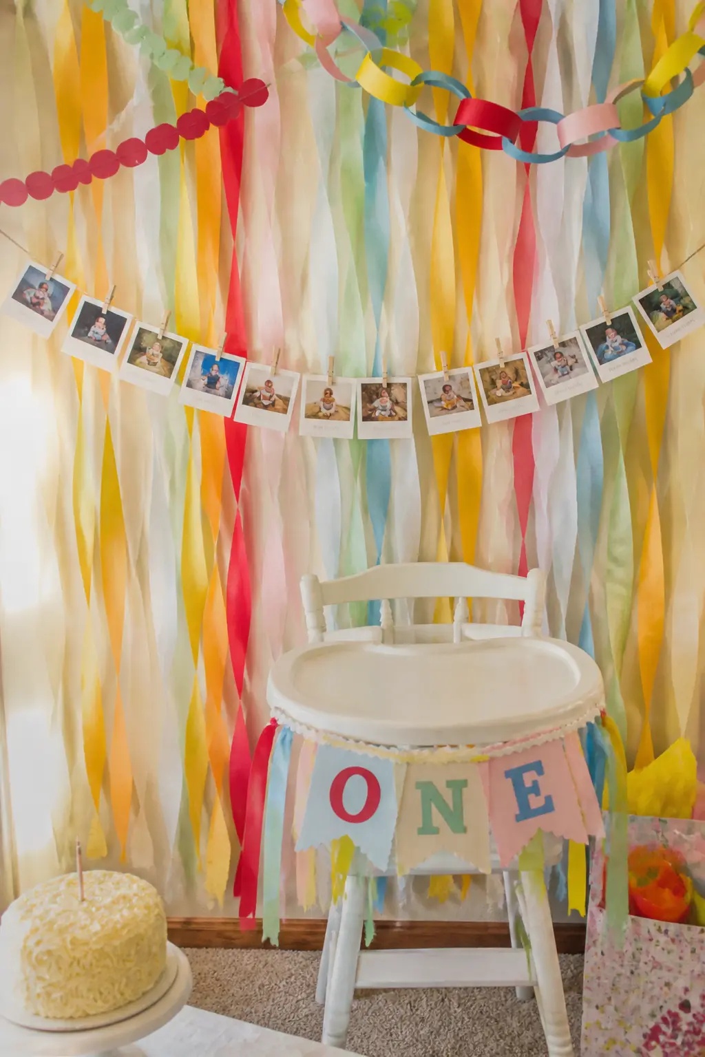 Photo Garland First Year Memory Banner — Print twelve small square photos, one from each month of the first year, and clip them to a length of twine with mini