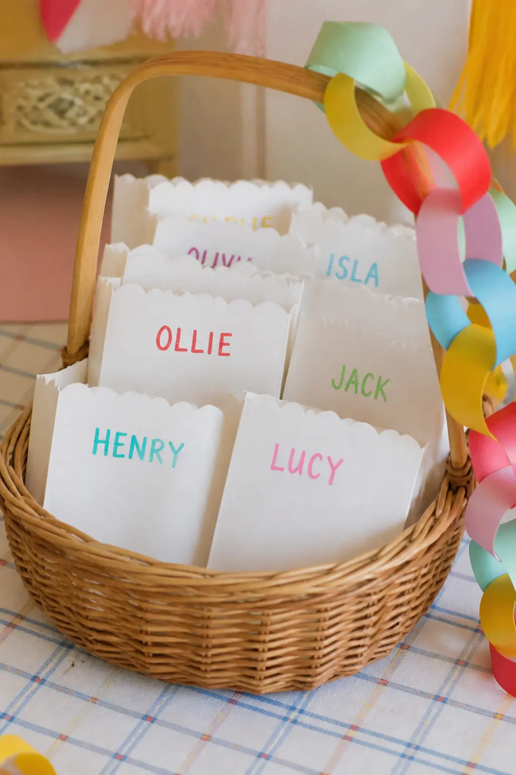 Scalloped Paper Goodie Bags with Name Tags — Cut a scalloped edge along the top of plain white paper bags using a decorative scissors or a punch, then stamp or