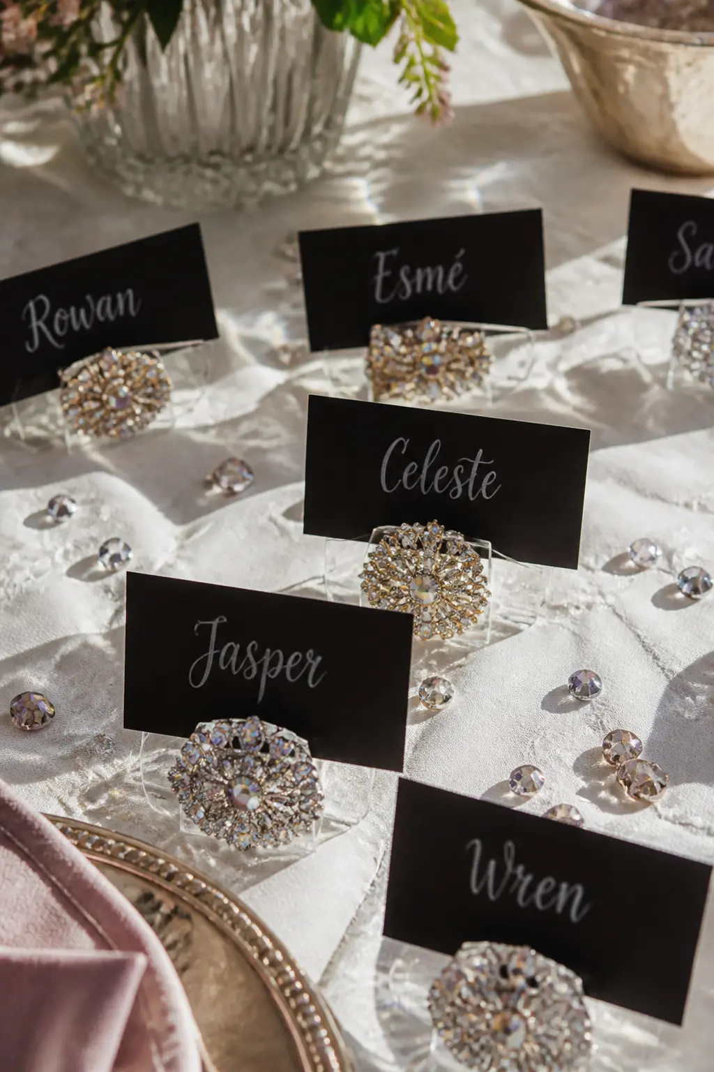 Crystal Place Card Holders — Buy plain acrylic or metal place card holders, then glue a cluster of three to five rhinestones onto the front face of each one.