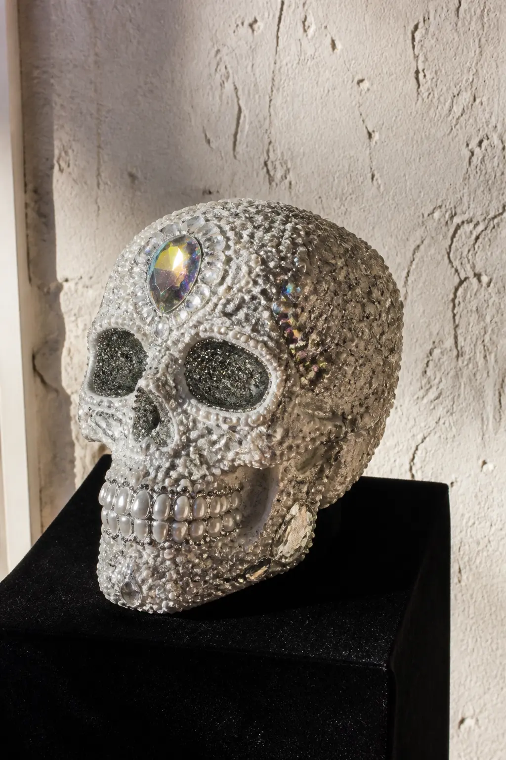 Crystal Skull Decorative Object — A resin or ceramic decorative skull, the kind sold in home decor shops rather than costume shops, gets an entirely new life