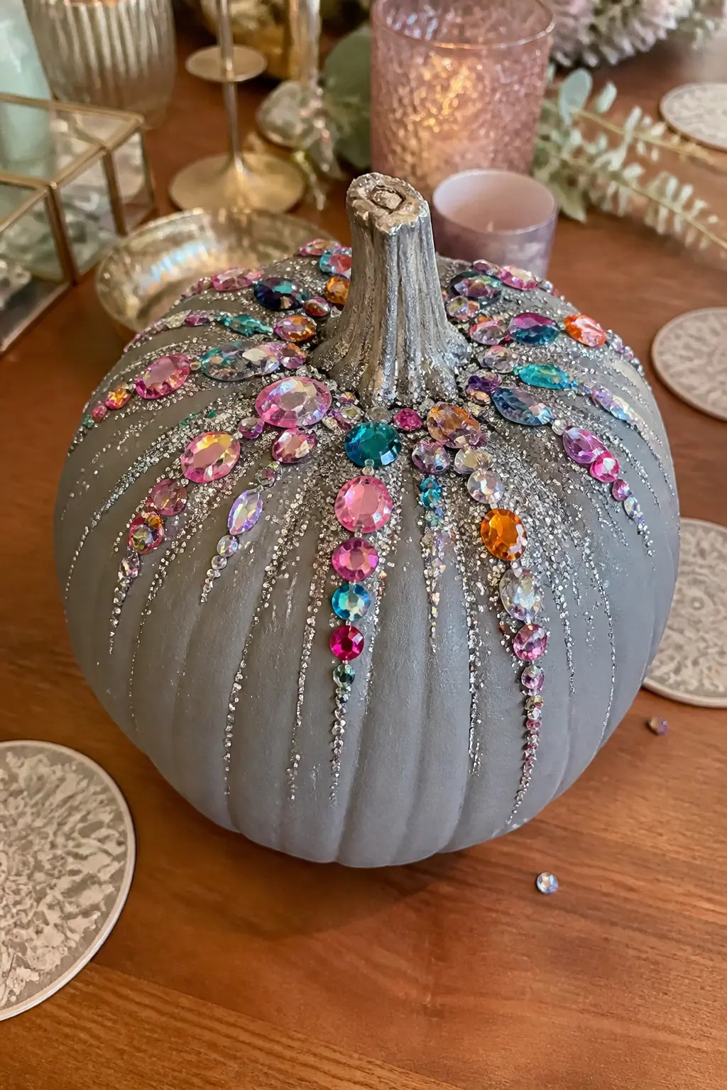Glitter-and-Gem Pumpkin with a Color Burst — Paint the pumpkin in flat warm grey or pale blue-grey. Bedazzled stuff