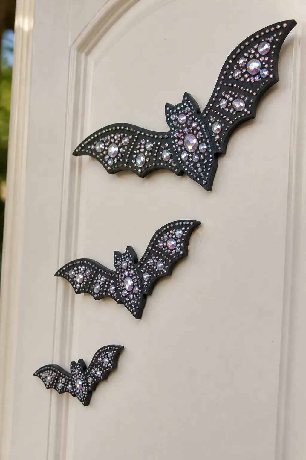 Jewelled Foam Bat Door Cluster — Cut bat shapes from black craft foam in three sizes, then cover each one in black and gunmetal rhinestones, pressing gems into