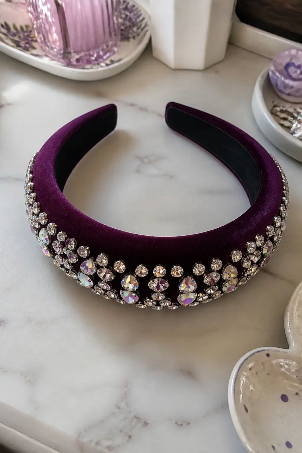 Rhinestone-Trimmed Velvet Headband — A wide velvet headband, preferably in deep plum or black, gets a band of rhinestones across its front face, running edge