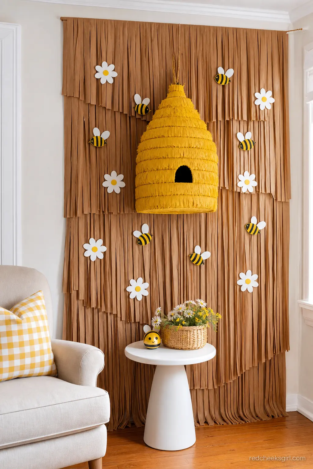 Beehive Piñata Wall Backdrop — A round paper beehive hung against a fringed wall costs less than a printed backdrop and looks considerably more expensive. Bee