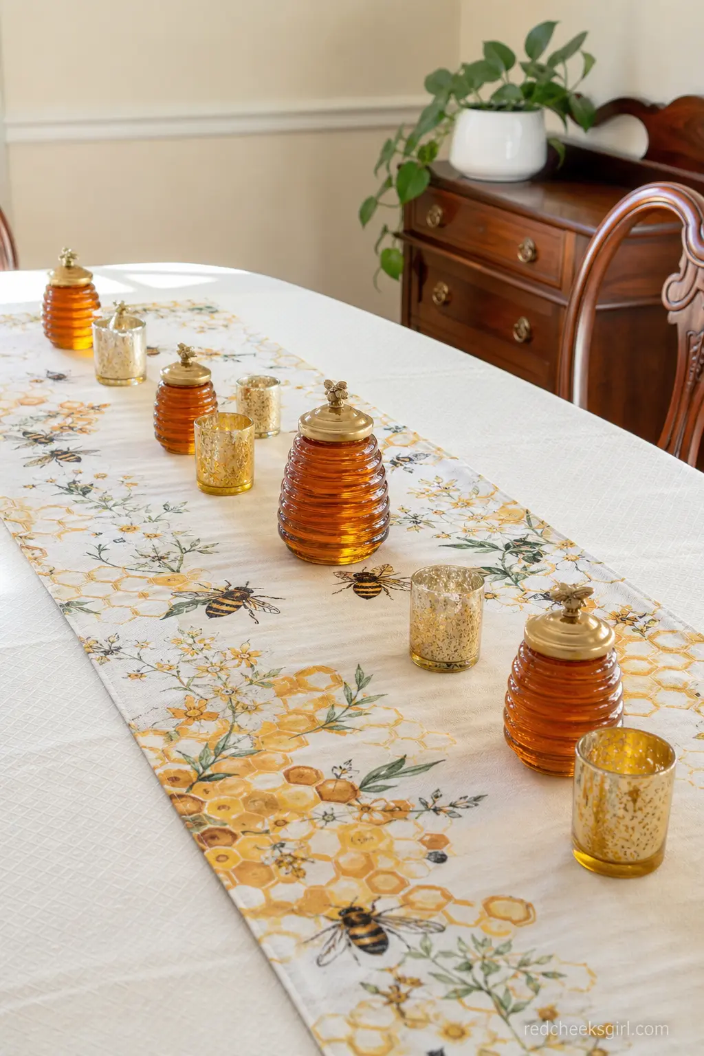 Honey Jar Table Runner — A row of amber jars down the center of the table costs less than fresh flowers and never wilts before the cake gets cut. Bee baby