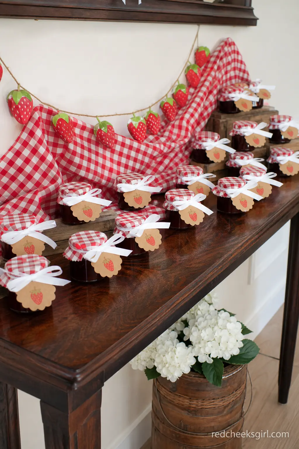 Mini Jam Jar Favor Table — Mini jars of strawberry jam wrapped in kraft labels are a favor guests actually use. Berry sweet baby shower theme