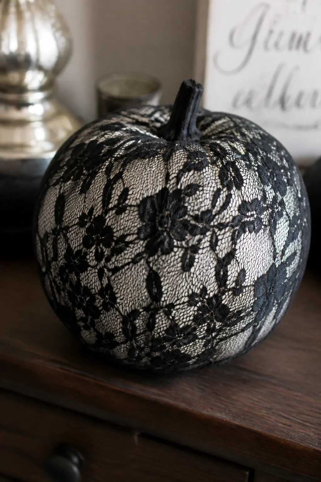 Black Lace Glued over a White Pumpkin — Cut a piece of black lace fabric large enough to drape over the top and sides of a white pumpkin, leaving the base