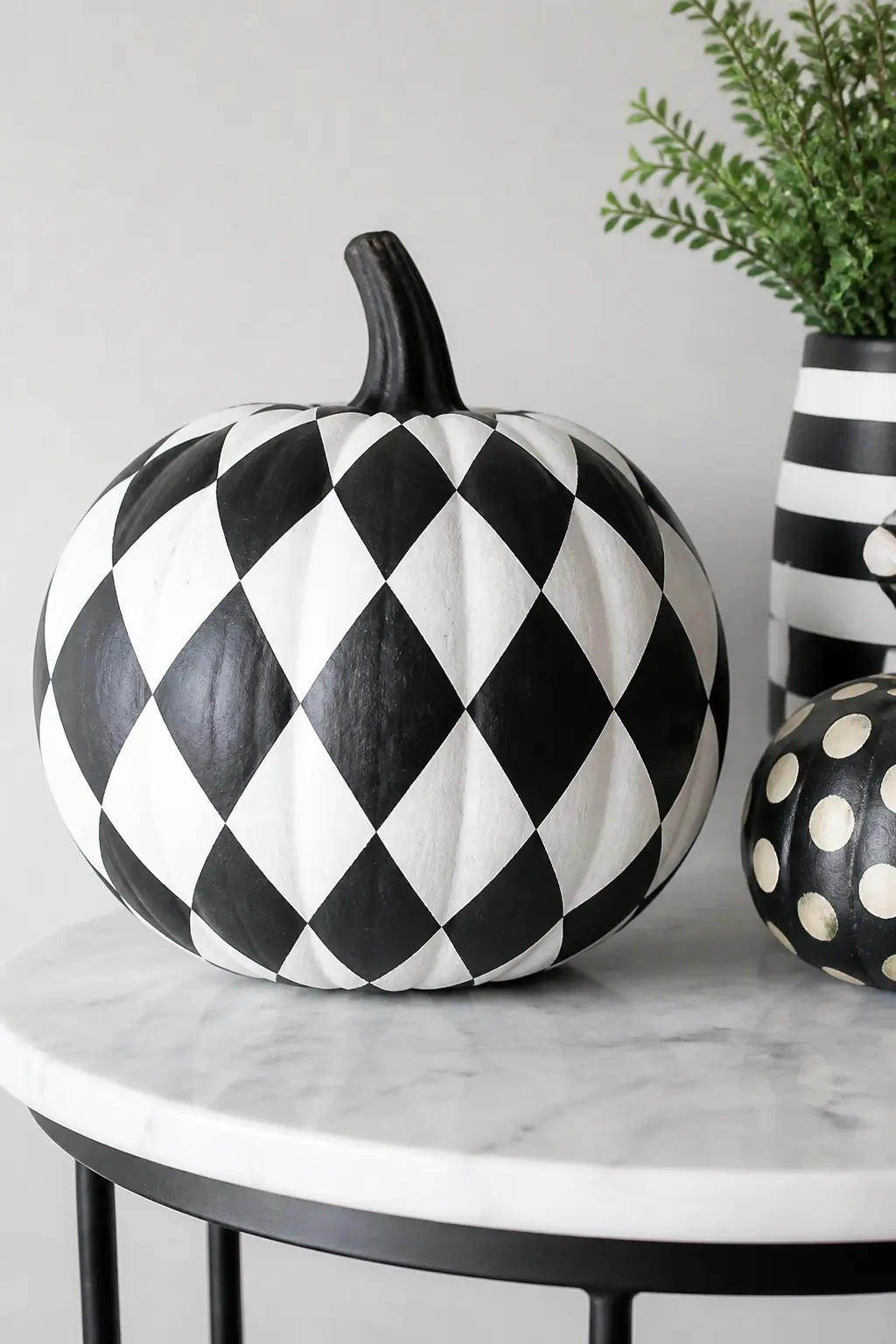 Harlequin Diamonds — Rotate the checkerboard grid forty-five degrees and you have a harlequin. Black and white painted pumpkin