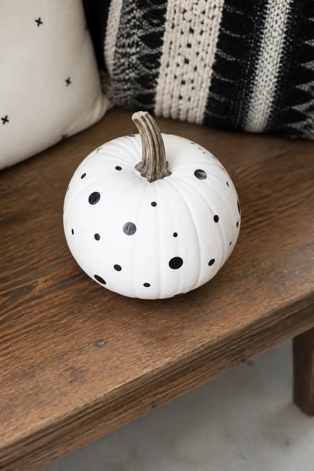 Scattered Dots in Three Sizes — Use three different applicators: a large foam brush, a standard brush tip and a pencil eraser, each loaded with black paint.