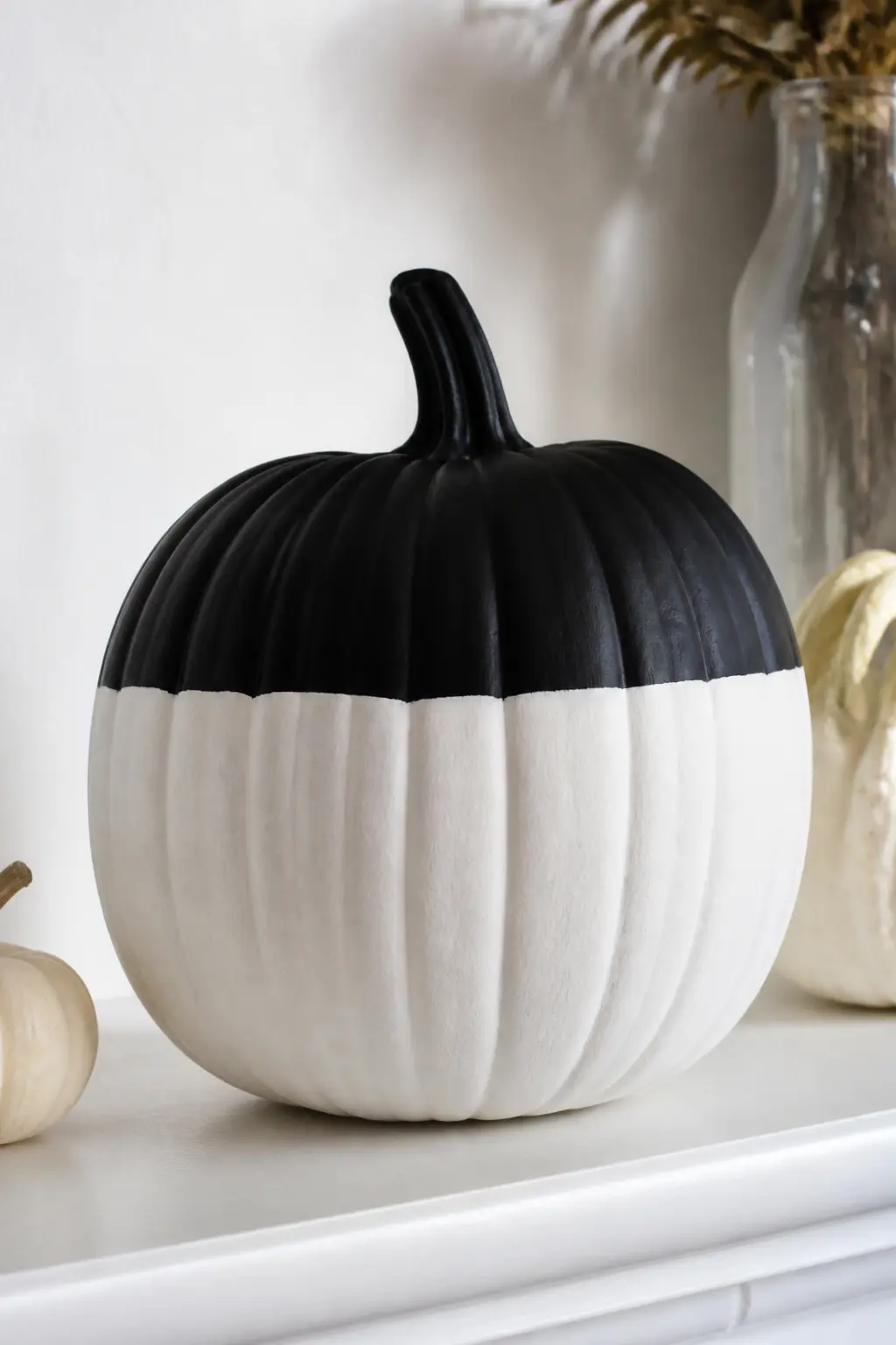 White Body with the Top Third Black — Base coat in white. Black and white painted pumpkin