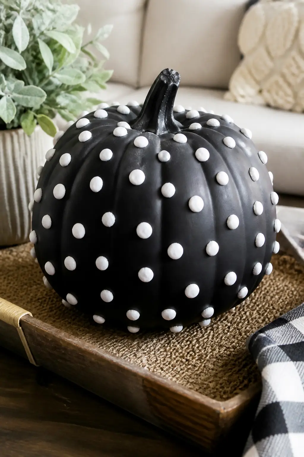 White Clay Dots Pressed onto a Black Pumpkin — Base coat in matte black. Black and white painted pumpkin