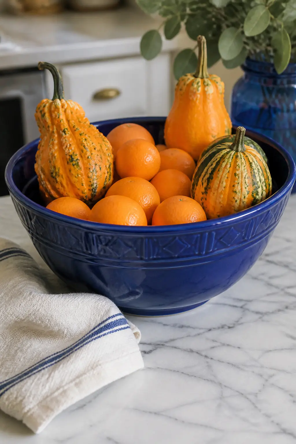 Blue Ceramic Mixing Bowl with Clementines and Mini Gourds — A wide blue ceramic mixing bowl, the kind already living in most kitchens, becomes a seasonal