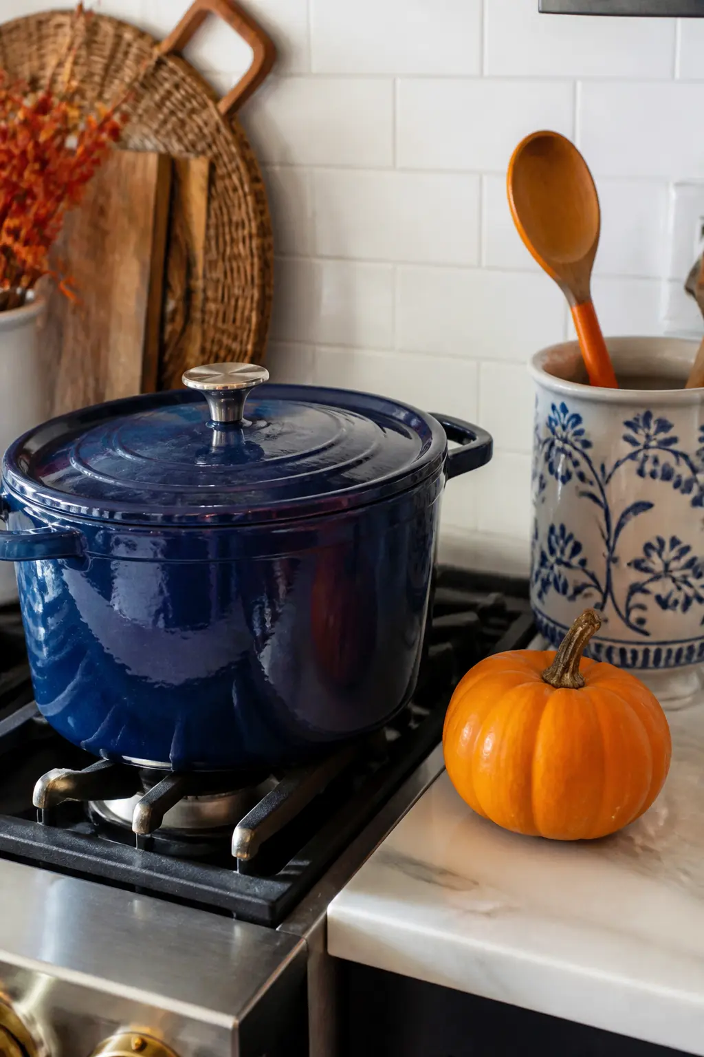 Navy Enamel Cookware as Kitchen Decor — Navy enamel cookware left out on the stovetop or hanging from a pot rack is kitchen decor that also cooks dinner, which