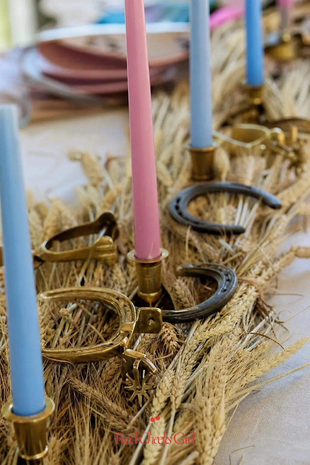 A Brass Spur And Candle Runner — Down the center of the table, lay a narrow strip of dried wheat and lay a few brass spurs and small horseshoes along it