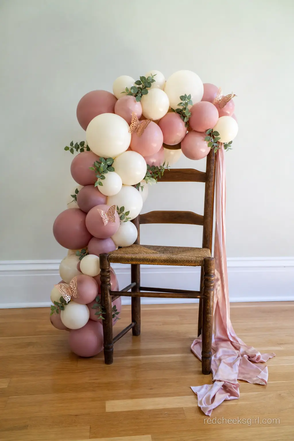 Dressed Mama-to-Be Chair with Balloon Garland — The guest of honor's chair should look different from every other seat in the room, and a small balloon garland