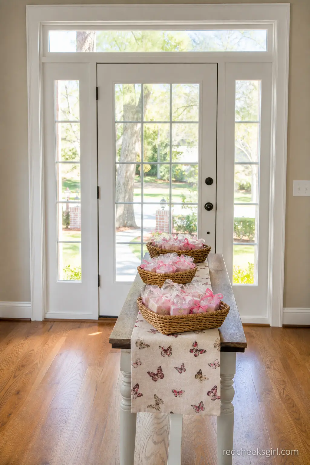 Exit Table with Butterfly Runner and Favor Baskets — A small table by the door with a short butterfly-print runner and a few baskets of favors sorted by type
