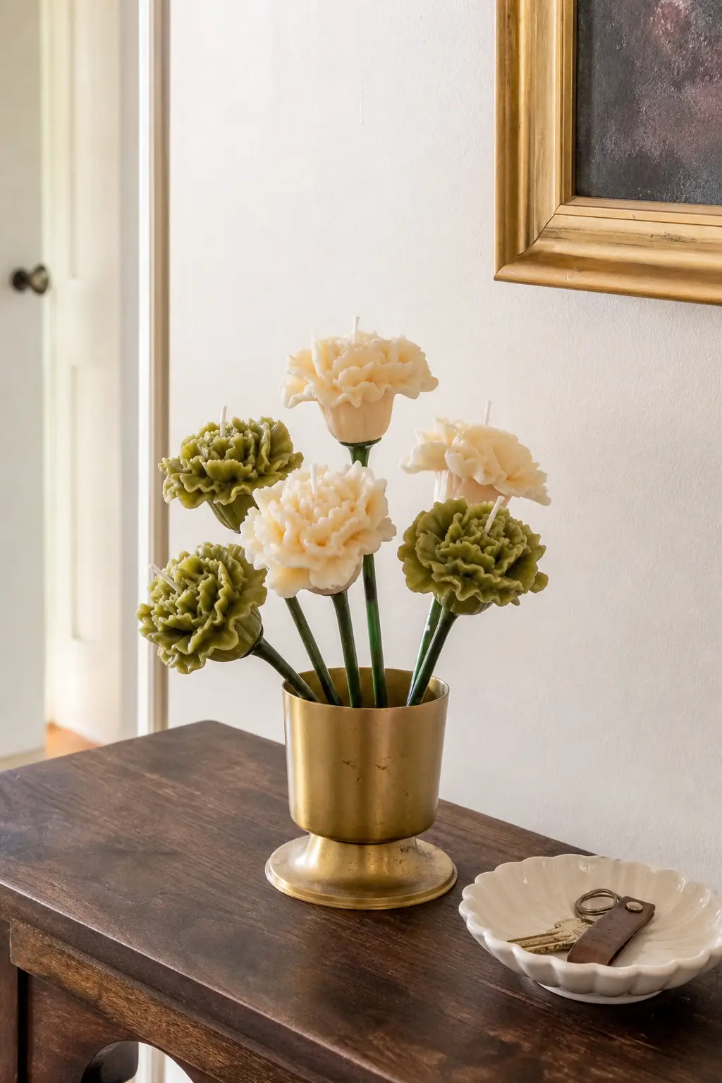 Botanica Hearth — Ruffled carnation candles in cream and olive green, a good shape for a thank-you because carnations photograph as generous even in a small