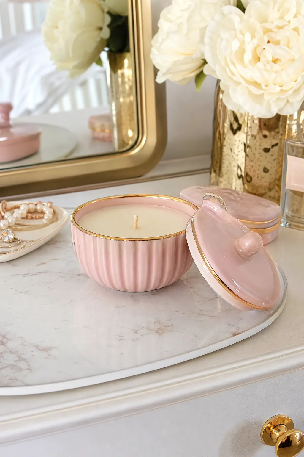 Blush Ceramic Trinket Dish Candle with Lid — A small lidded ceramic trinket dish, blush pink with a thin gold rim, becomes a candle you close between burns