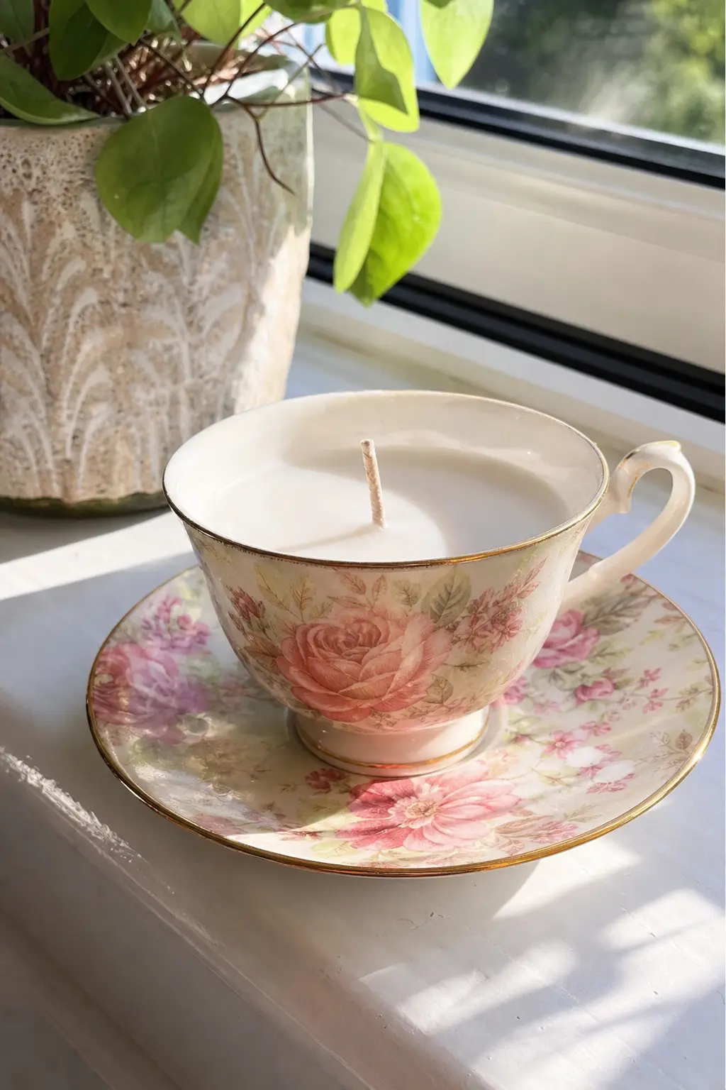Teacup Candle in a Floral Bone China Cup — A cracked-glaze teacup with a gold rim holds a candle better than most new containers, because the shape was already