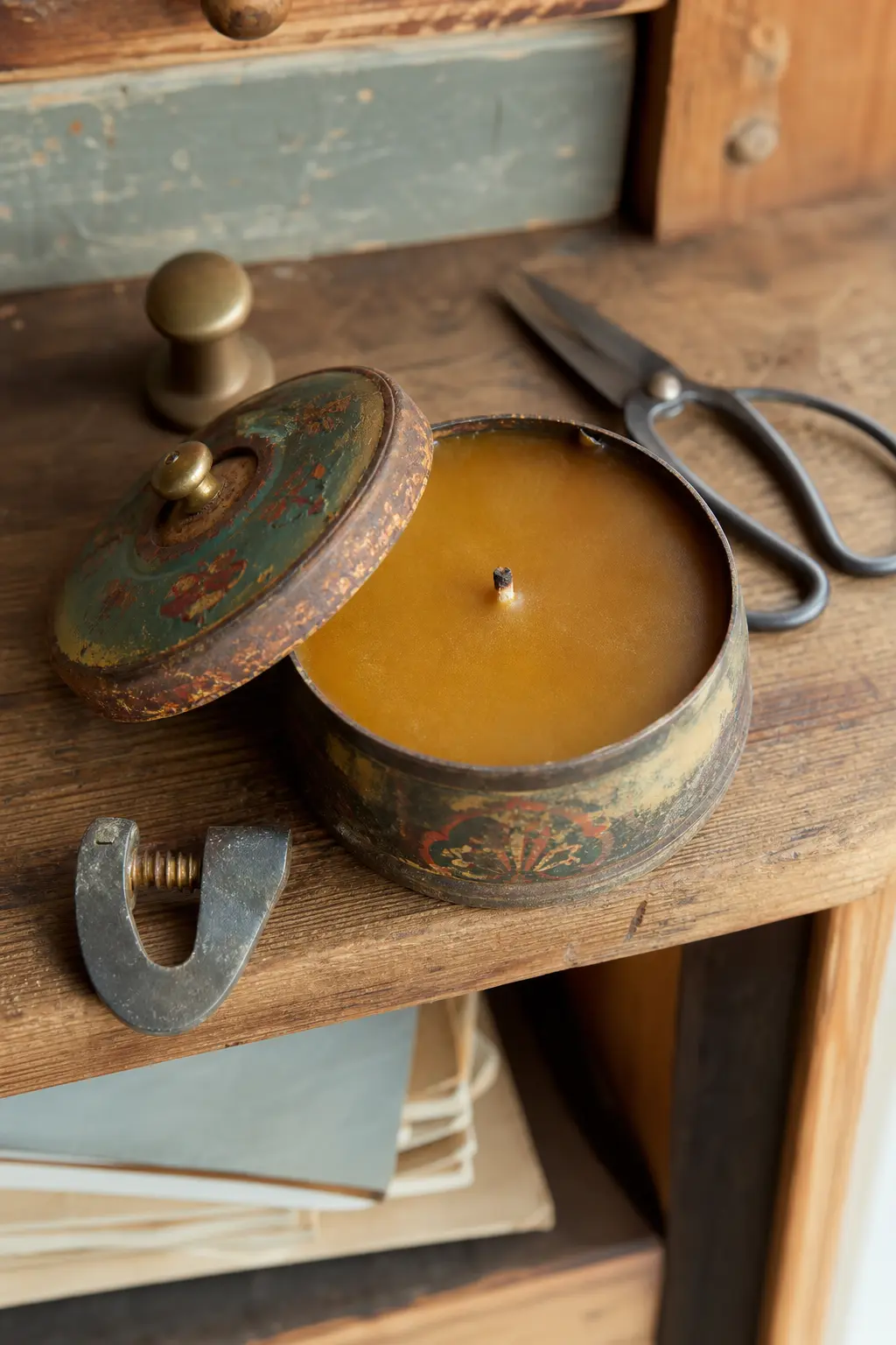 Vintage Tin Candle with a Push-Lid — An old tobacco or spice tin with a bit of rust at the seam makes an amber candle look like it was always meant to live