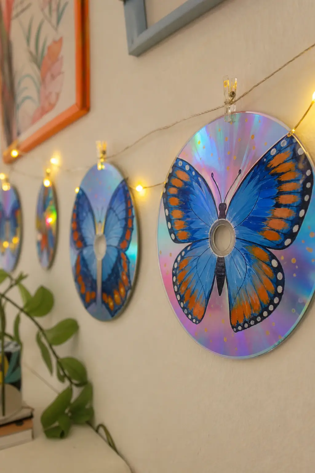 Butterfly Wings — Symmetrical wings in cobalt blue with orange edging, meeting at the centre hole as the body, use the one part of a CD every other design has