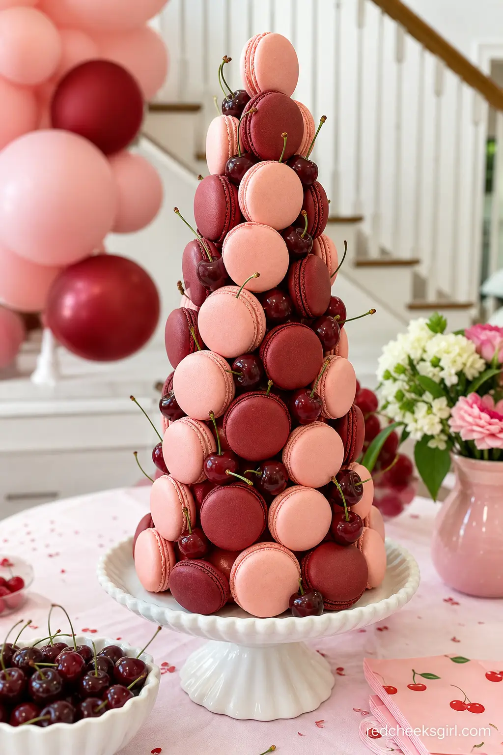 Blush and Burgundy Macaron Tower — A cone shaped macaron tower alternating pale pink and deep burgundy shells gives the dessert table height without a second