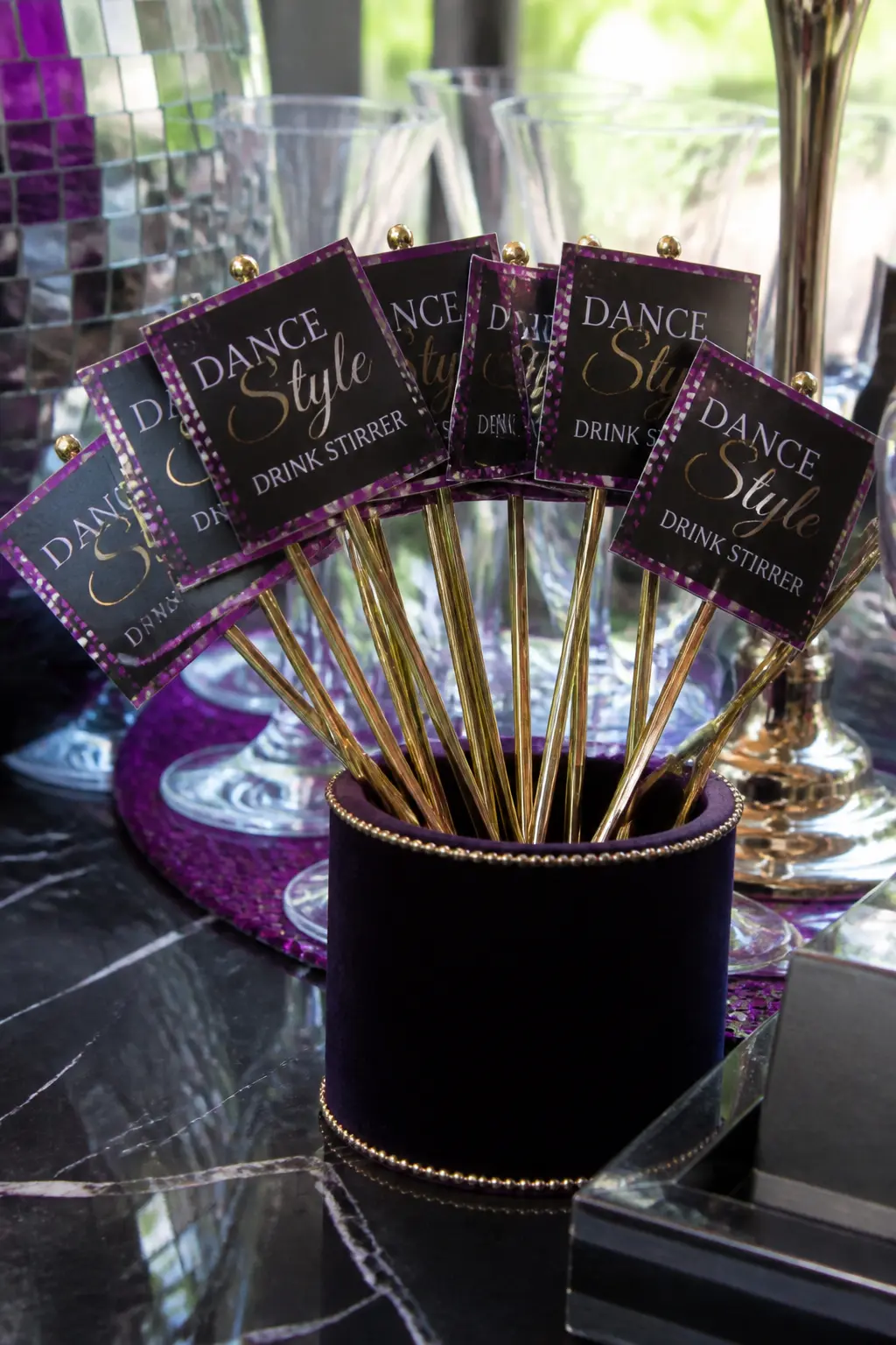 "Dance Style" Drink Stirrers — Gold foil cocktail stirrers, each labelled with a different ballroom dance style (Waltz, Tango, Foxtrot, Samba, Cha-Cha), stand