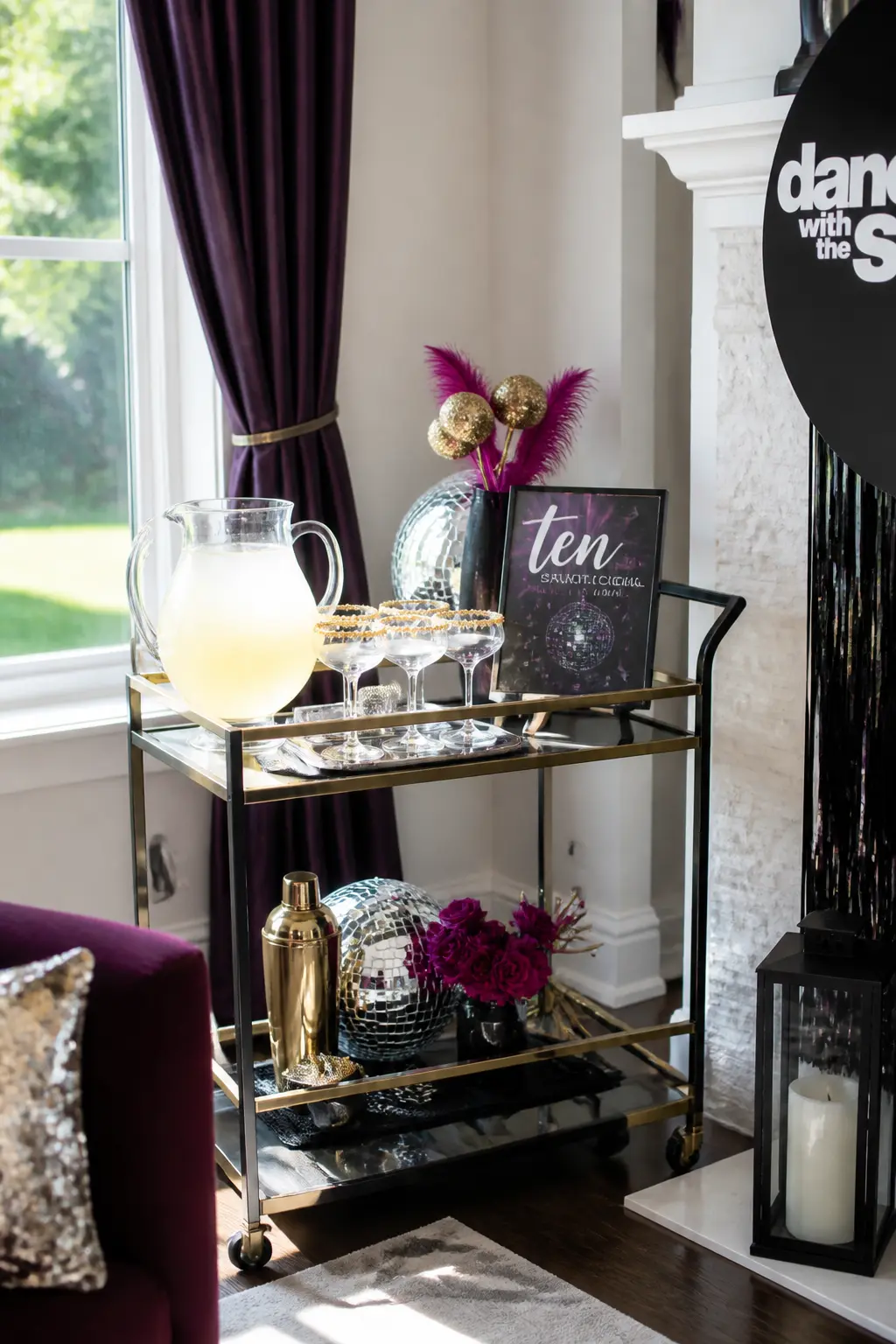 The "Ten" Signature Cocktail Bar — A bar cart or kitchen counter dressed in black and gold holds one pre-batched signature cocktail called "The Perfect Ten." A
