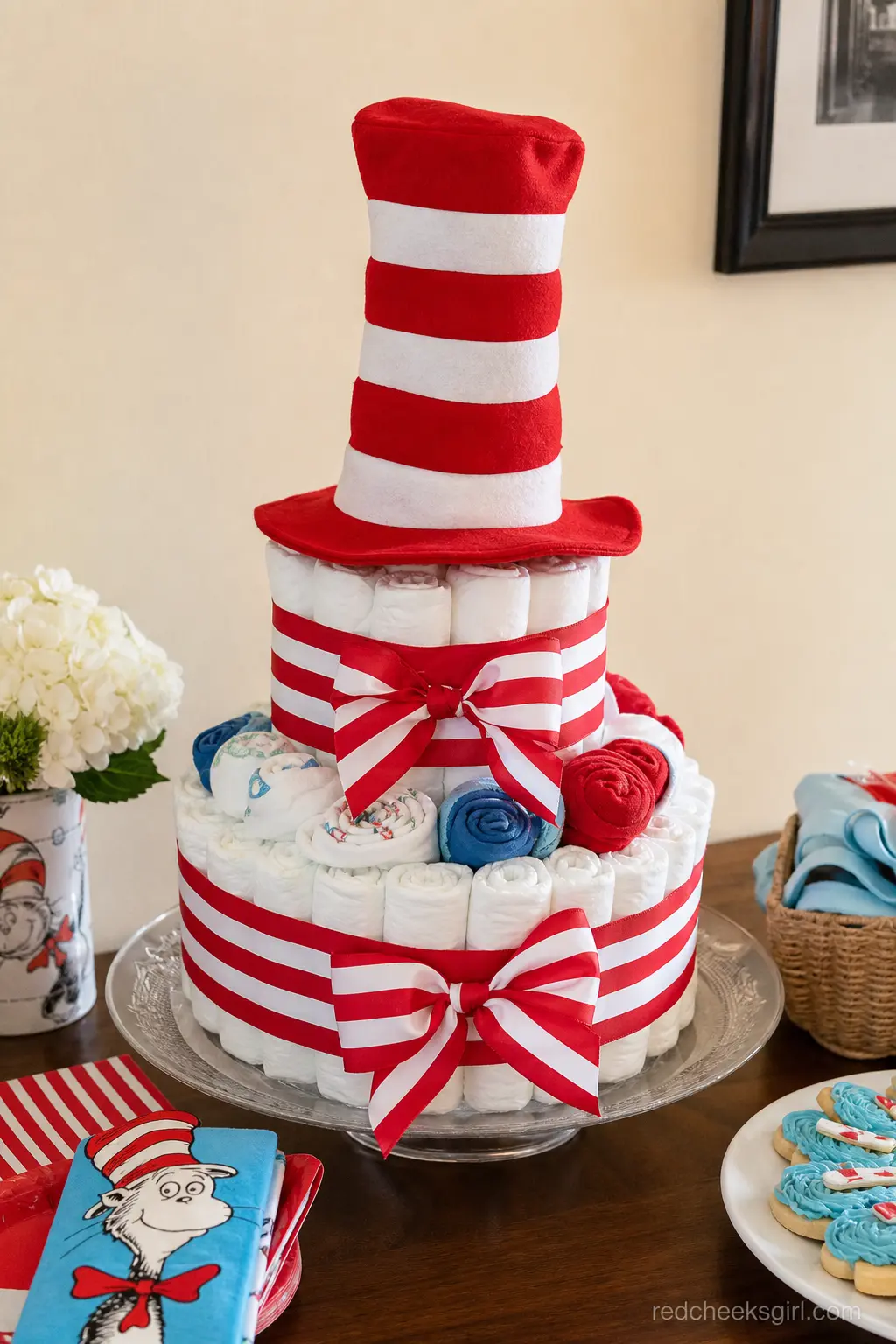 Red and White Storybook Hat Diaper Cake — Bold red and white striped ribbon wraps every tier, finished with a tall red and white striped hat prop on top