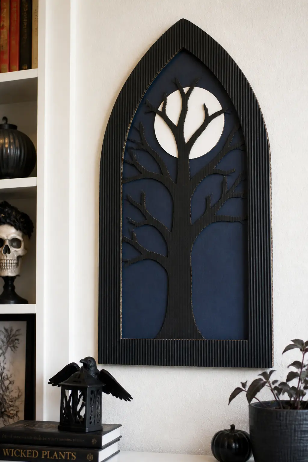 Gothic Arch Window Silhouette — Cut a pointed arch frame from black corrugated board to fit a blank wall section. DIY cardboard Halloween decorations