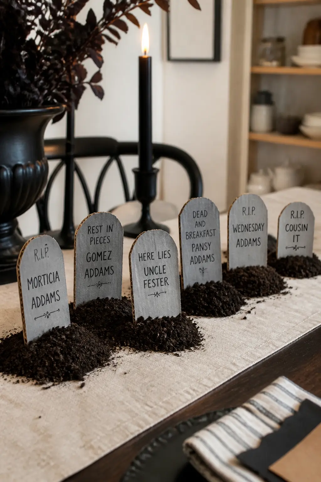 Mini Tombstone Place Cards — Cut tombstone shapes, rounded top with a slight taper, from grey-painted corrugated board scraps. DIY cardboard Halloween