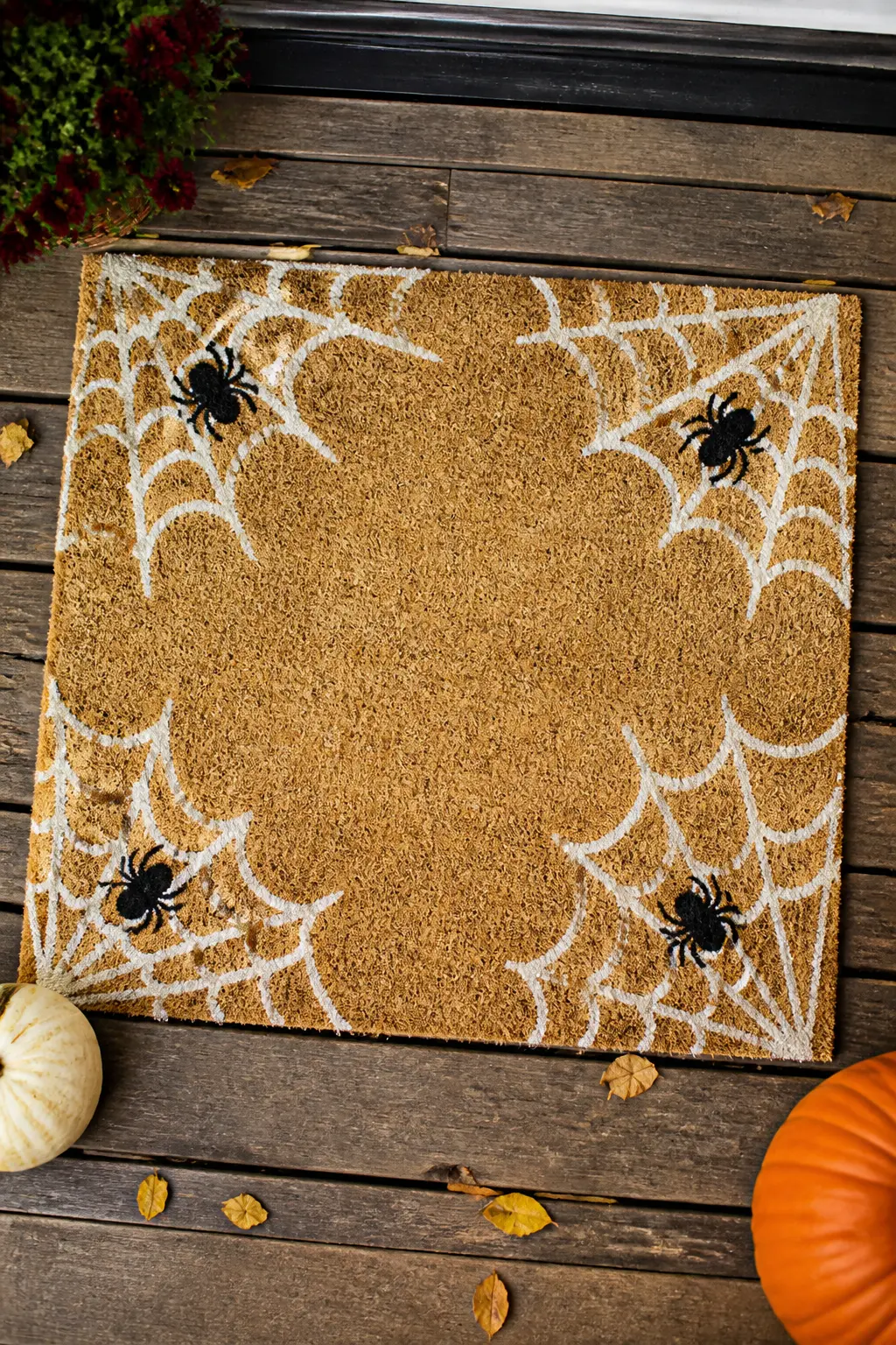 Cobweb Border with Open Center — A web painted in white in all four corners simultaneously, each radiating outward from the corner point with arcs connecting