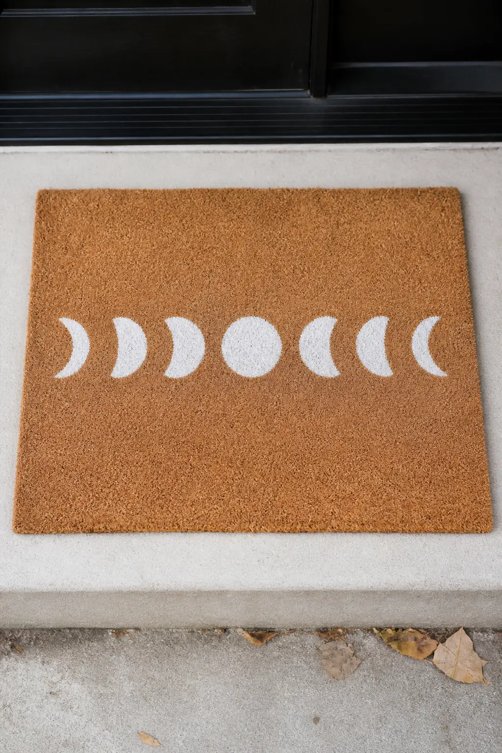 Moon Phase Row Across the Center — Seven moon phases painted in a centered horizontal row across the mat: full circle, three-quarter crescent, half circle