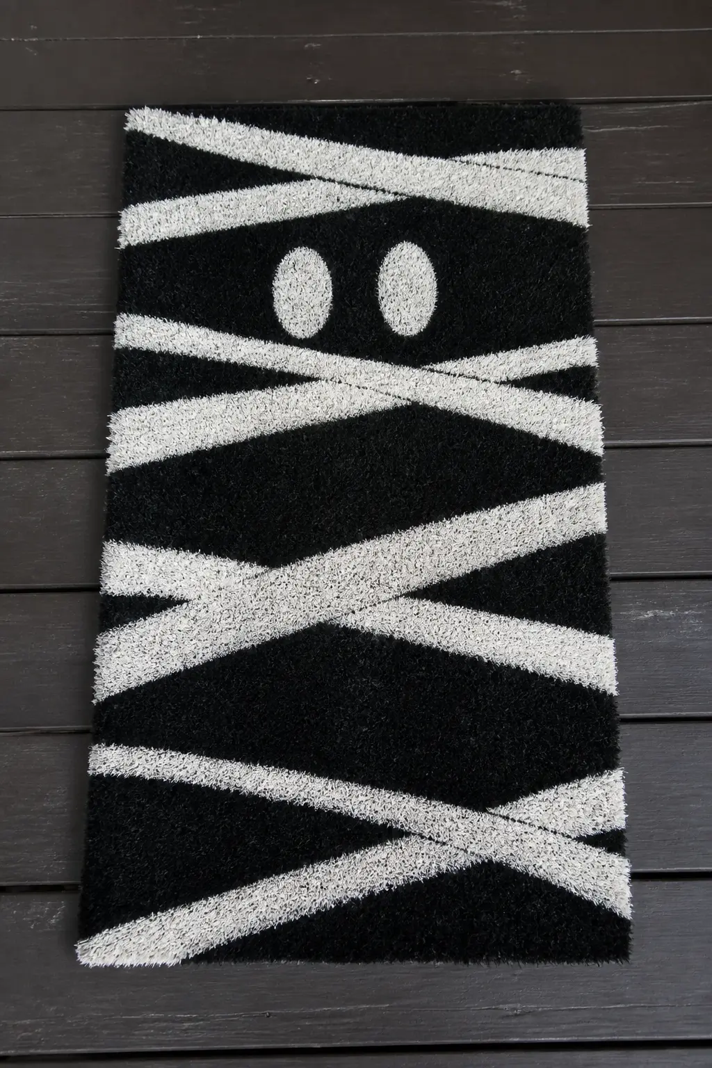 Mummy Wrap Pattern in White on Black — The mat is painted fully black as a base, then diagonal bands of white painted across it in rough horizontal strips to