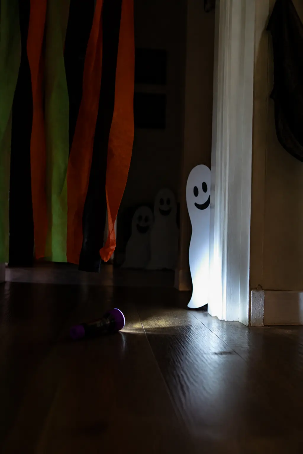Flashlight Ghost Hunt — Cut small ghost shapes from white card stock, about the size of a playing card, and hide fifteen of them around a darkened room or