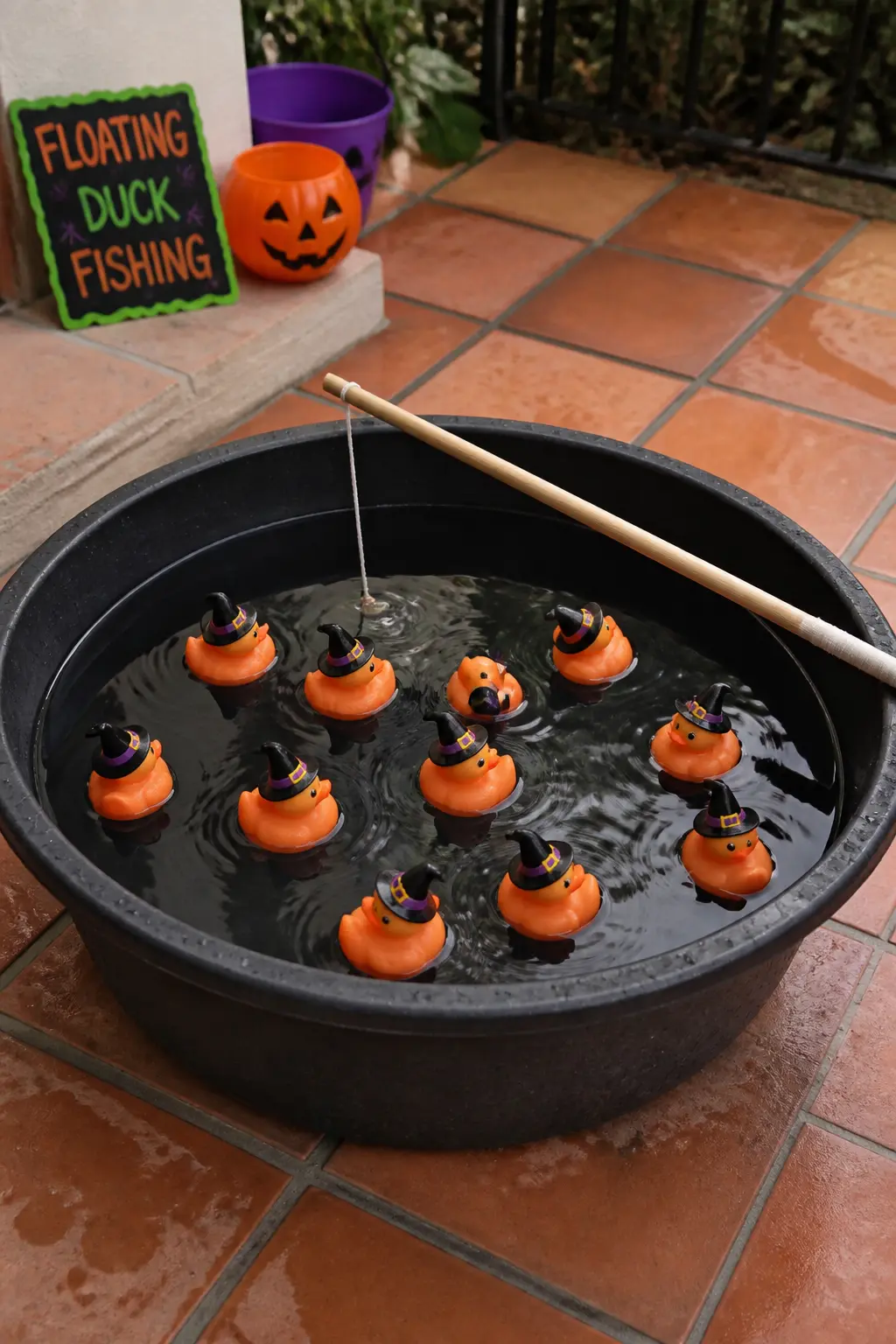 Floating Duck Fishing — Fill a large black plastic tub with water and float a mix of regular yellow rubber ducks and orange rubber ducks with tiny witch hats