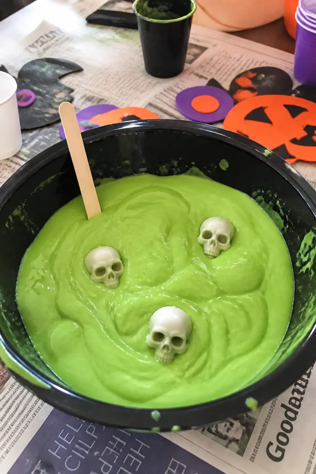 Slime Dig — Mix a batch of green slime from PVA glue, water and borax solution, and bury ten small plastic spiders and skulls inside it in a large black bowl.