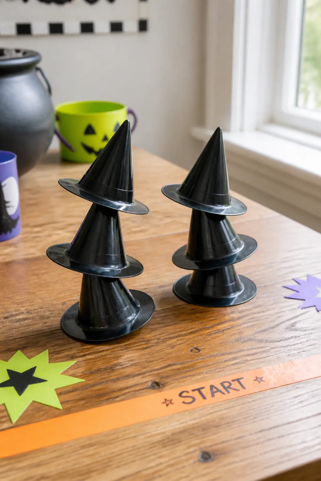 Witch Hat Stack Relay — Stack three small plastic witch hats on each player's head. Diy halloween games for kids
