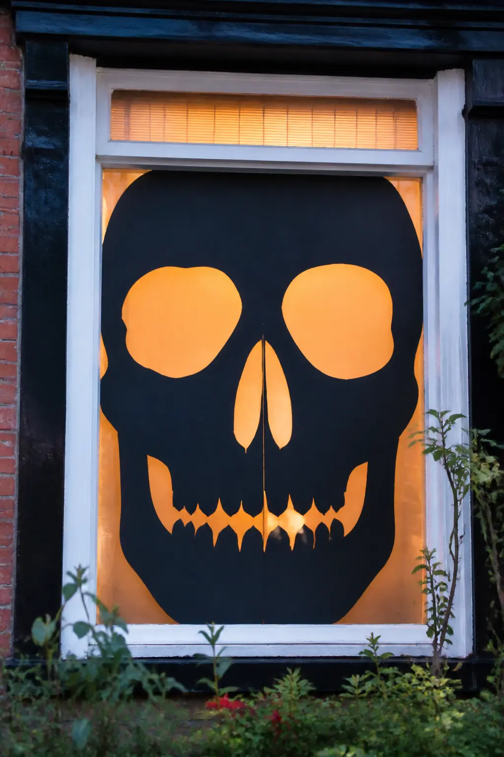 Giant Skull Centred in a Pane — Cut a skull face to fill one full window pane, edge to edge. Diy halloween window silhouettes