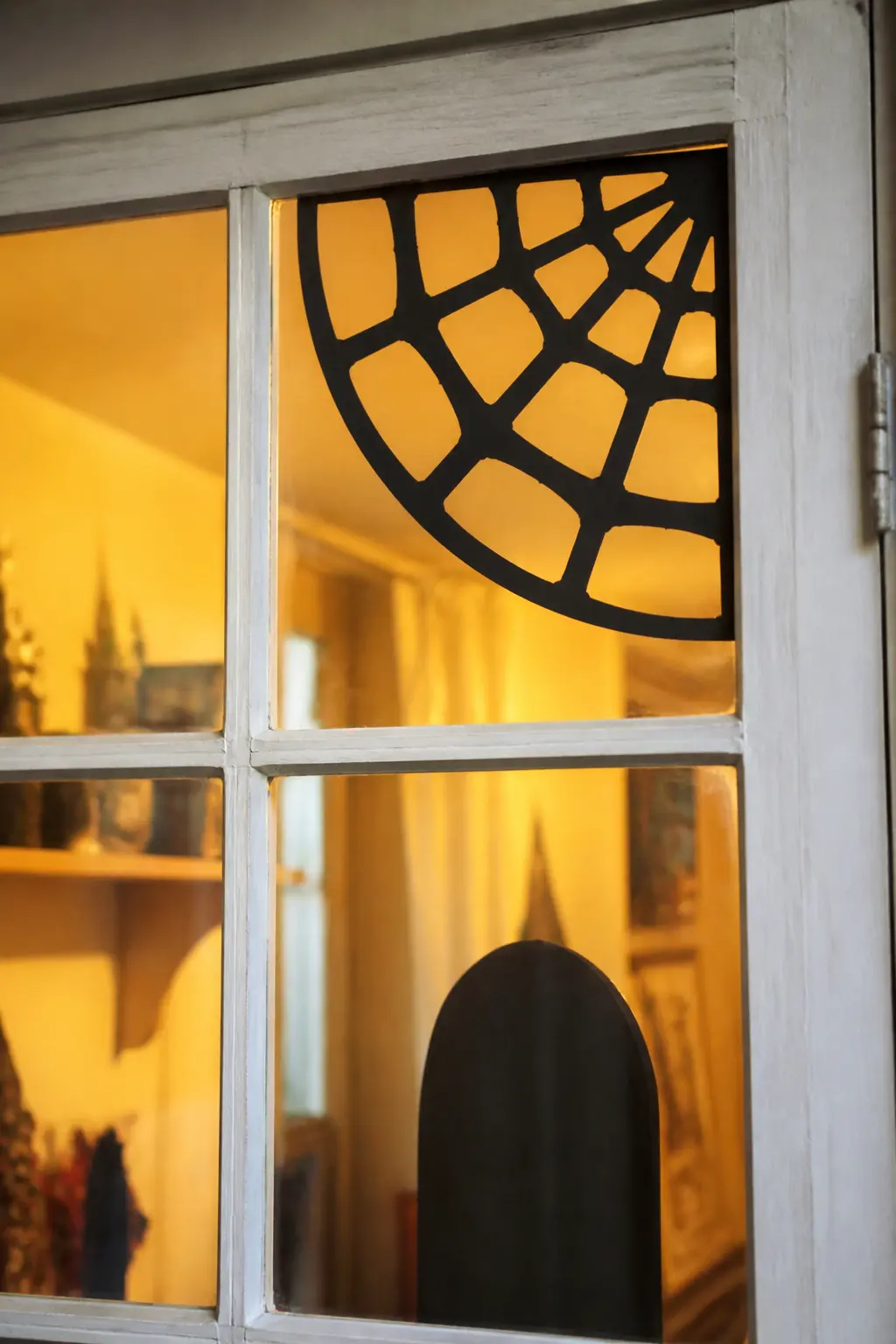 Spider Web in a Corner Pane — Cut a quarter-circle web shape to fit exactly into one corner pane of a multi-pane window. Diy halloween window silhouettes