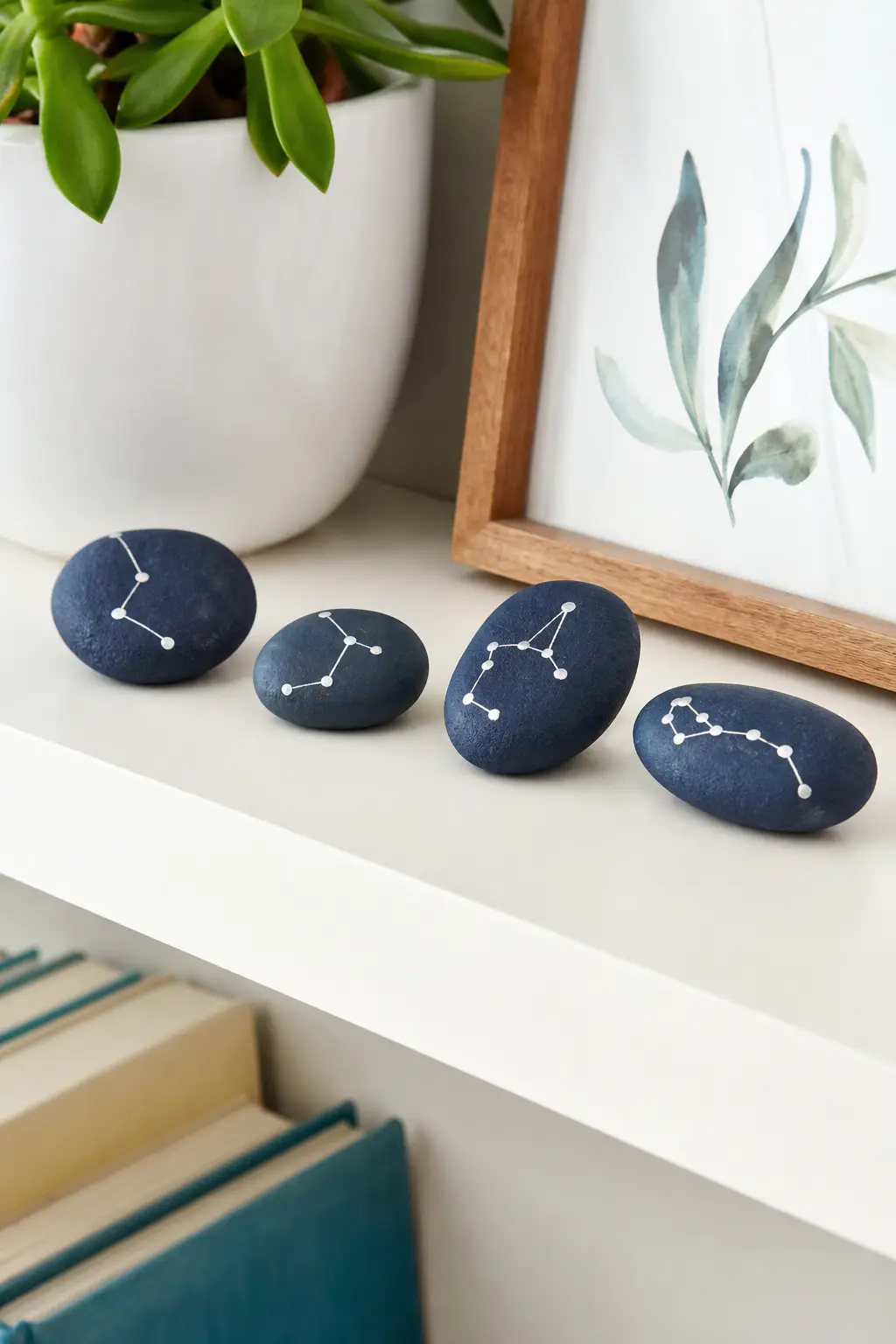Constellation Star Map Stones — A navy or deep indigo base coat sets the night sky, then silver paint dots mark the stars before a fine liner pen connects them