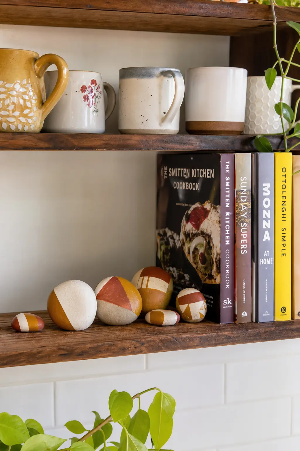 Geometric Color-Block Stones — Painter's tape masks off clean triangles and blocks in mustard, rust and cream, so the lines come out crisp without a single